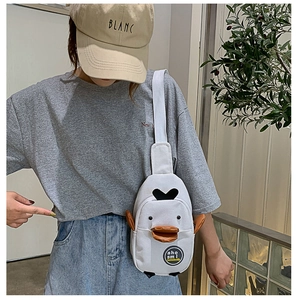 Detail of cute white duck canvas chest bag featuring 3D orange beak and badge