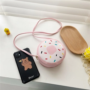 Close-up of pink doughnut shaped kids crossbody bag with colorful sprinkle print detail