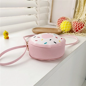 Close-up of pink doughnut-shaped girl's crossbody bag with colorful sprinkle print decor