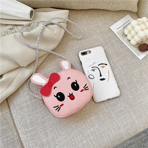 Pink cartoon bunny mini crossbody bag detail showing small size compared to a smartphone