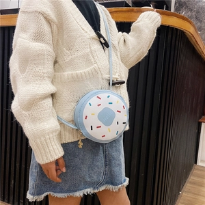 Detail of light blue donut shaped crossbody bag with Hello print and golden bear zipper