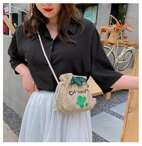 Detail of hand-woven bucket bag with cactus embroidery and drawstring closure
