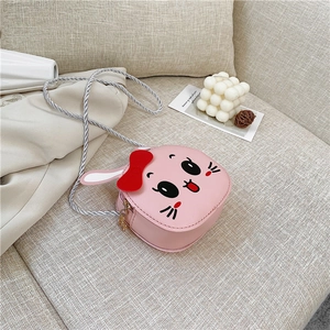 Pink cartoon rabbit bag for kids with red bow and star zipper on a cozy sofa background