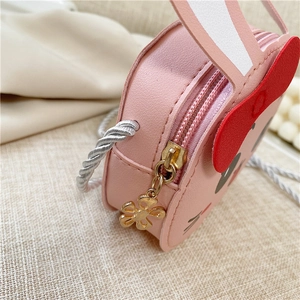 Detailed side view of pink PU leather kids crossbody bag with floral zipper charm