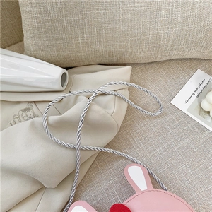 Detail of pink rabbit kids crossbody bag with silver twisted strap and PU leather texture