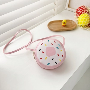 Close-up of pink doughnut-shaped crossbody bag for girls with colorful rainbow sprinkles