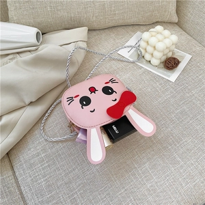 Pink rabbit crossbody bag for kids with red bow detail and woven rope strap