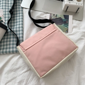 Minimalist pink and beige color-block canvas crossbody bag with adjustable black strap
