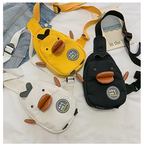 Detailed flat lay of cute cartoon duck canvas chest bags in yellow, black and beige colors