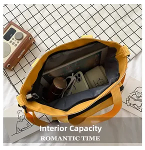 Detailed interior of a yellow oxford cloth tote bag showing large capacity for essentials
