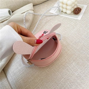 Close-up of pink bunny crossbody bag showing zipper closure and rope shoulder strap