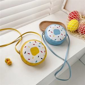 Detail of yellow and blue donut crossbody bags for girls with Hello print and dots