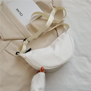 Detail of minimalist white nylon crescent bag with adjustable wide fabric strap