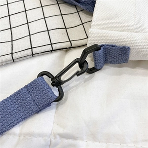 Close-up of durable canvas bag strap with high-quality rotating plastic swivel hook