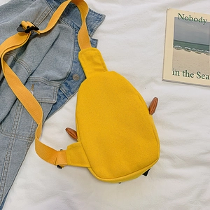 Bright yellow canvas crossbody bag with cartoon duck ears on clean white cotton fabric