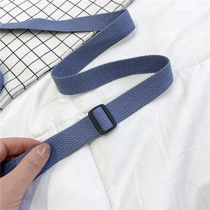 Close-up of adjustable grey-blue twill canvas strap with black matte slide buckle