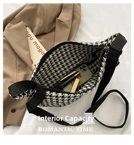 Macro detail of houndstooth crossbody bag interior showing spacious storage for cosmetics