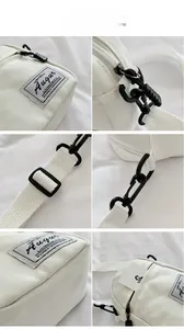 Macro detail of high-density canvas bag showing black swivel hooks and brand woven label