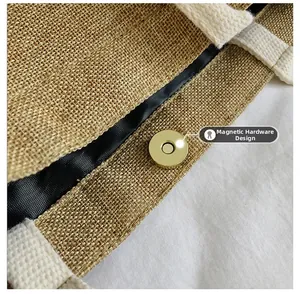 Detail of golden magnetic clasp on jute tote bag with durable white woven cotton handles