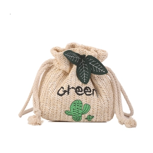 Handmade woven straw bucket bag with green cactus embroidery and leaf drawstring detail
