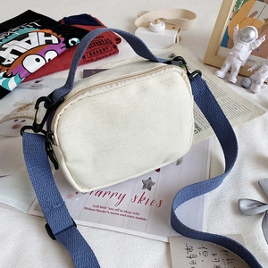 Cute Korean style cream canvas crossbody bag with navy blue straps and zipper