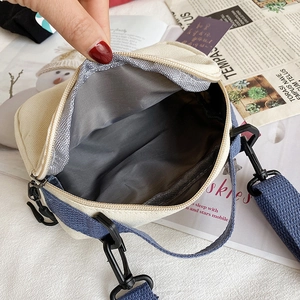 Japanese style canvas crossbody bag with navy blue strap and inner fabric lining