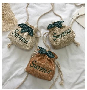 Three straw drawstring bags in beige and brown with Summer embroidery and leaf details