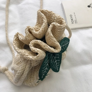 Handmade straw bucket bag with green leaf patches and adjustable cotton rope strap