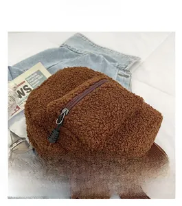 Close-up of brown teddy fleece backpack with fuzzy texture and zipper front pocket