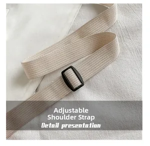 Detail of the adjustable woven shoulder strap with a black buckle on the nylon bag