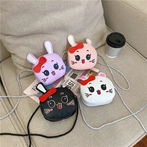 Close-up of cute cartoon bunny shoulder bags in purple pink black and white for children