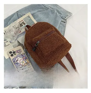 Close-up of brown teddy fleece mini backpack showing soft plush texture and zipper detail