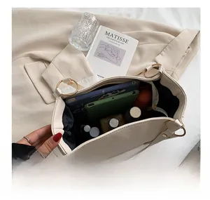 Top view of spacious cream leather tote bag interior storing tablets and essentials