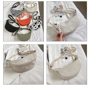Detail showing cow print and solid color nylon crescent crossbody bags with wide straps