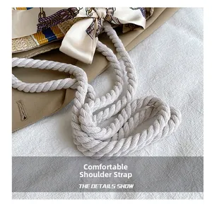Detail of woven beach tote featuring durable cotton rope handles and printed silk scarf bow