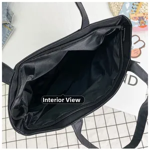 Top view of spacious interior with zipper closure in black canvas tote bag
