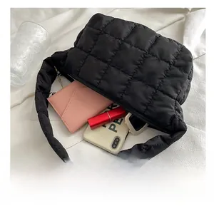 Macro shot of large black quilted shoulder bag interior showing spacious capacity