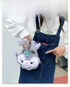 Close-up of soft purple plush rabbit crossbody bag featuring a teal bow detail