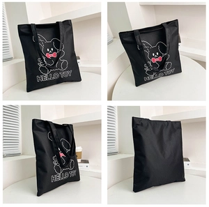 Detail view showing four angles of a black canvas tote bag with a cartoon rabbit and Hello Toy text