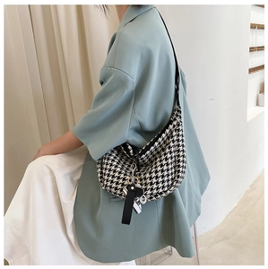 Classic houndstooth crossbody bag styled with a light blue shirt for a casual daily look