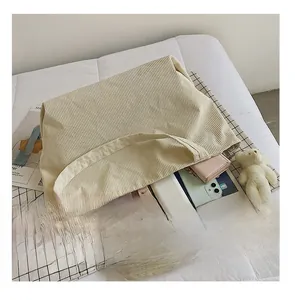 Detail view of large corduroy tote bag showing spacious interior for tablets and cosmetics