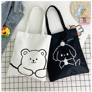 Detail of canvas tote bags with cute cartoon bear and dog prints on checkered background