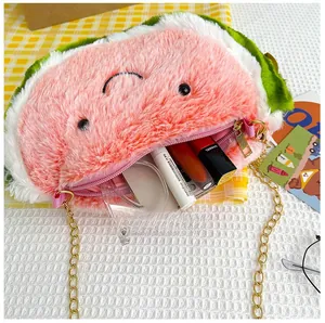 Detail of plush watermelon bag showing internal capacity for cosmetics and chain strap