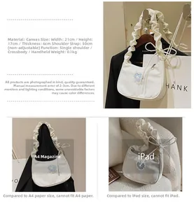 Detailed size guide for white canvas tote bag with heart patch and blue handle detail