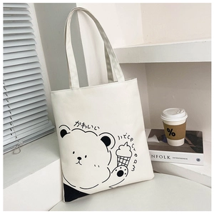 Close-up of white canvas tote bag featuring a cute cartoon bear and Japanese text