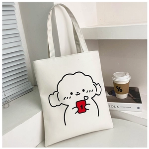 Detail of white tote bag featuring cute cartoon puppy print and smooth leather texture
