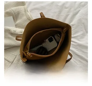 Detail view of large tote bag interior capacity with a matching zipper pouch organizer