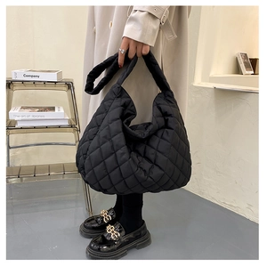 Close-up of black quilted tote bag with soft padded texture and large capacity