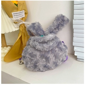 Detail of grey fluffy bunny plush bag featuring soft curly fur and purple strap