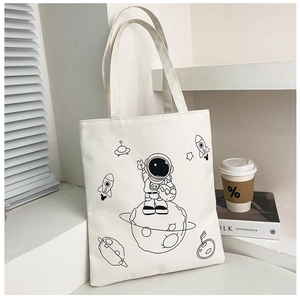 Detail of white canvas tote bag featuring minimalist black line astronaut illustration